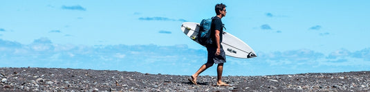 Surfer walking with surfboard