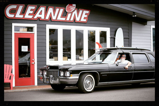 Tom with his epic car and longboard single fin strapped to the roof.